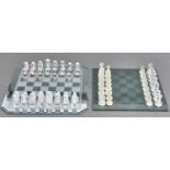 A Regency Fine Arts lead crystal chess set,  with frosted and clear glass board, the pieces