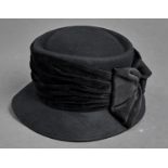 Millinery. A black felt lady's hat with velvet bow by Sandra Phillipps Good condition