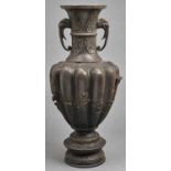 A Japanese bronze lobed oviform vase, Meiji period,  with elephant head handles, cast with lapets