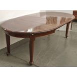 A mahogany extending dining table, c1920's, the oval ended top with moulded lip above a shallow