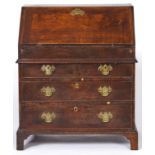 A George III oak bureau, with fitted interior, two short two long drawers on bracket feet, 111cm