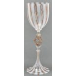 A Venetian glass goblet, 20th c, with latticino bowl and trumpet foot, centred by three strand