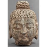 A South East Asian stone head of Buddha, 25cm h Some chips and losses particularly to the ears