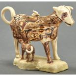 A Staffordshire creamware cow creamer and cover, early 19th c, with marbled or agate glaze, the