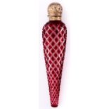 An Edwardian silver gilt capped ruby flashed and cut glass scent bottle, of icicle form, the cap