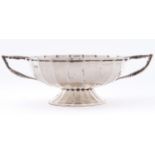 An Edwardian fluted silver bonbon dish, with angular handles on flared foot, 18cm over handles, by