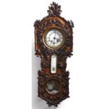 A Continental walnut veneered and carved wall clock, c1880, the ornate door applied overall with oak