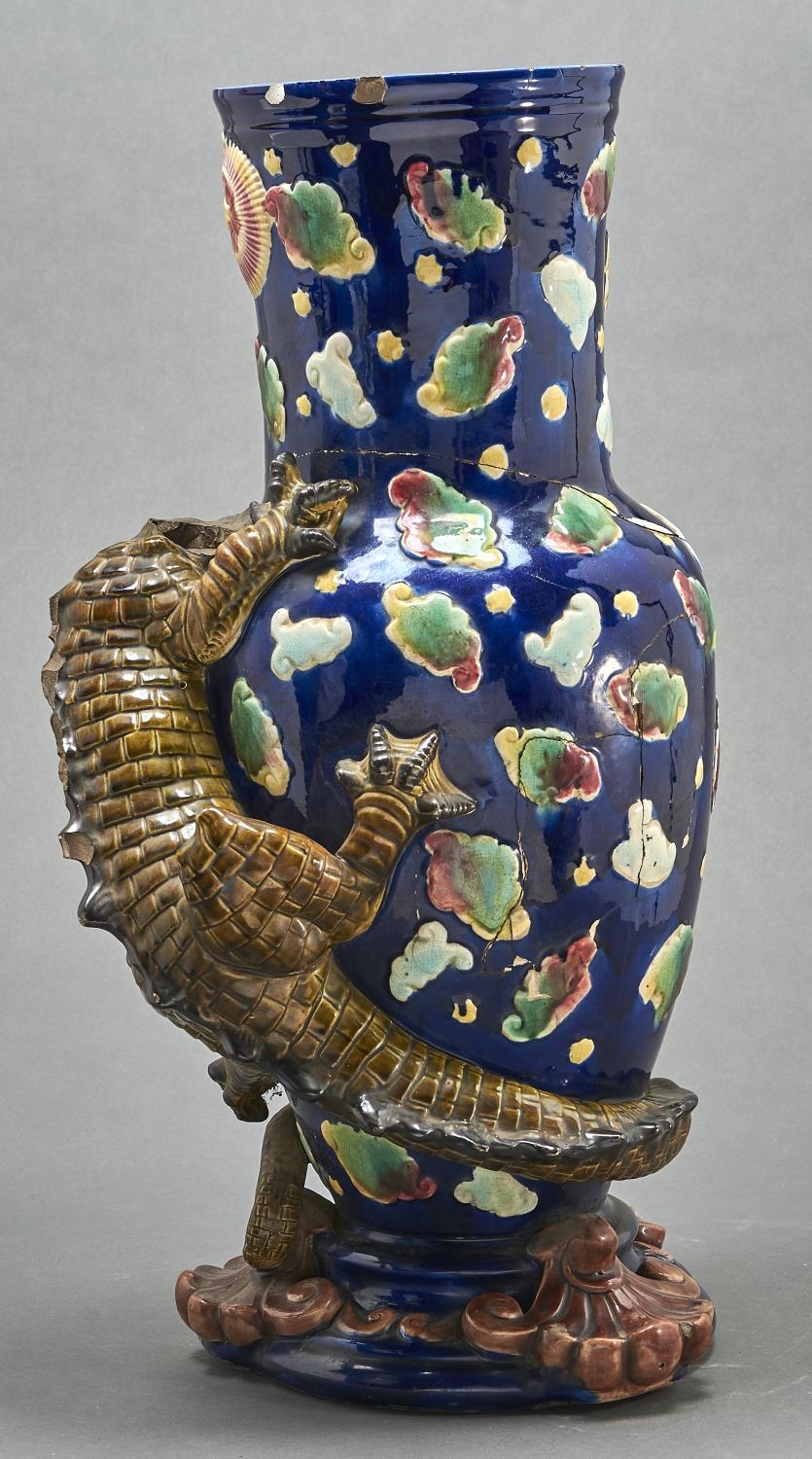 A majolica dragon vase, late 19th c, the scaly olive green creature clinging to the blue vase, the