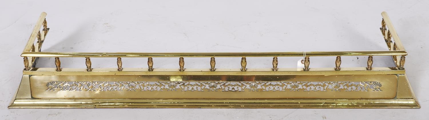An Edwardian pierced brass fender, c1905, splay fronted beneath gallery, 37 x 126cm Good condition