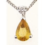 A yellow sapphire and diamond pendant, in white gold, on a white gold necklet marked 375, 1.2g