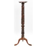 A mahogany torchere, incorporating a Victorian bedpost, 137cm h, top 27cm diam Rim of top chipped,