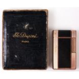 A gold plated and black lacquer cigarette lighter, by S T Dupont, Paris, original box Good