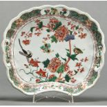 A Chinese famille verte shell shaped dish, Qing dynasty, Kangxi period, painted with a tree peony