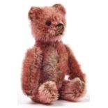 A Schuco miniature pink teddy bear novelty powder compact, with mirror, c1920, 10cm h Good condition
