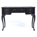 A late Victorian ebonised mahogany writing table, c1880, the shaped rectangular top inset tooled red