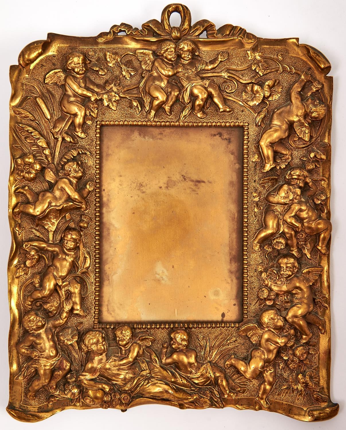 A gilt brass photo frame decorated with cherubs, late 19th c, 29 x 23cm Good condition; requires a