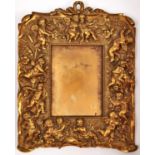 A gilt brass photo frame decorated with cherubs, late 19th c, 29 x 23cm Good condition; requires a