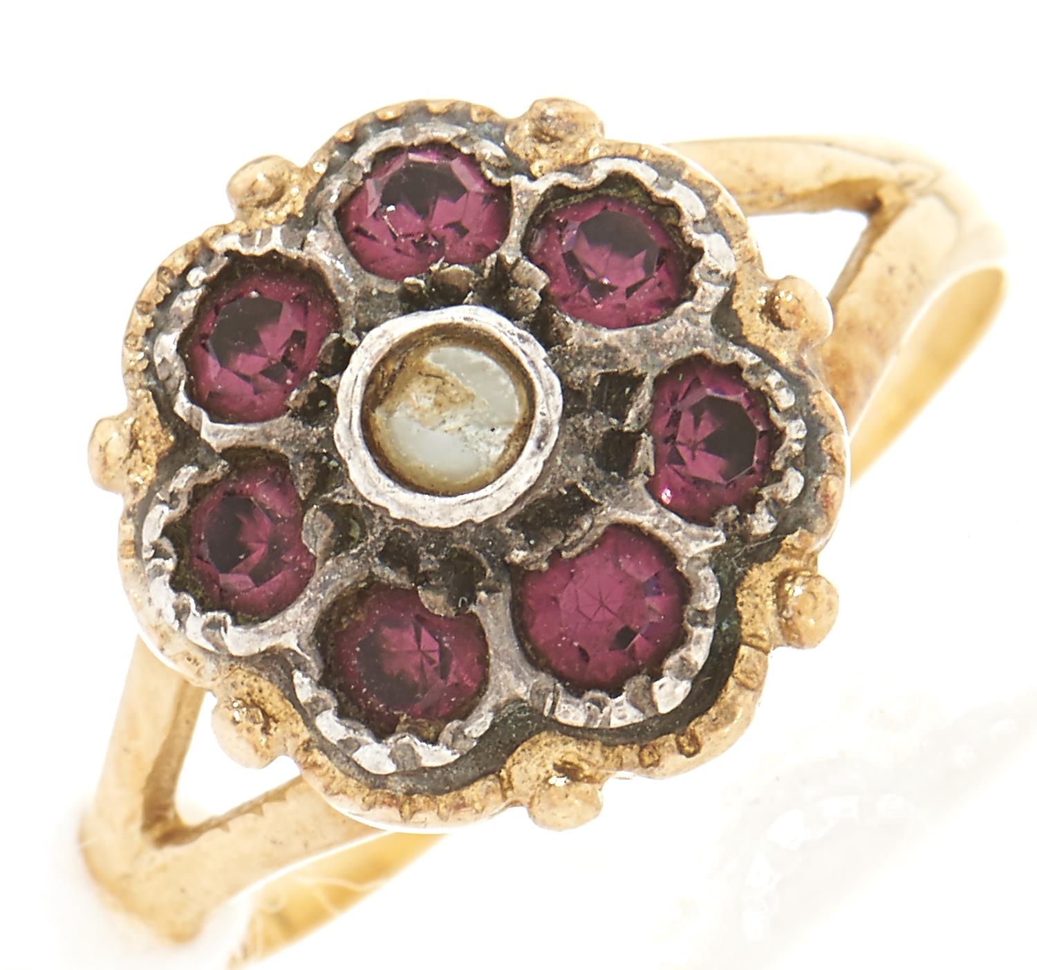 A paste cluster ring,  in gold marked 750, 3.6g, size L