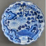 A Japanese blue and white dish, Arita, 18th c, painted with flowering plants in slightly upturned,