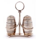 A George V silver cruet frame and pair of barrel shaped condiments, 9.5cm h, by The Gorham