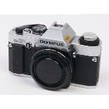An Olympus OM20 SLR 35mm camera body, with body cap, instructions and original box In apparently