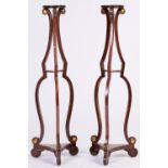 A pair of Regency brass mounted and brass line inlaid grained rosewood torcheres, of triple
