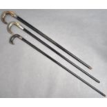 Three horn handles ebony walking canes, c1900, silver mounted, various lengths Typical knocks and