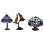 Two Tiffany style table lamps and another, similar, in the form of waterlilies, 40cm h x 6cm diam