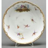 An English porcelain dessert plate, c1860, painted in the manner of John Randall with birds, lobed