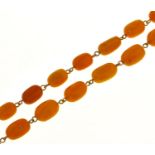 A necklace of 64 amber beads, 61.7g Evident from image