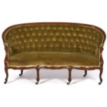 A French walnut sofa, late 19th c, on brass castors upholstered in buttoned green fabric, seat