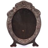 An Art Nouveau silver photograph frame, the mount die stamped with insects and entrelac, backed on