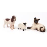 Three Beswick animals in the form of a spaniel, matt glaze, a Siamese cat and a ram Good condition