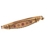 An Edwardian ruby and diamond bangle, gipsy set in 9ct gold, 66mm, maker CMW, Chester, date letter