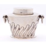 An Edwardian two handled oval silver tea caddy and cover, wrythen fluted, 7.5cm h, by W Hutton &