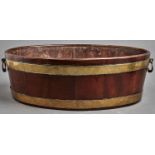 A George III brass bound oval mahogany wine cooler, late 18th c, with hinged brass handles, 19cm