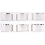 A set of six Elizabeth II silver napkin rings, shaped edge, quite plain, by The Barker Edwards