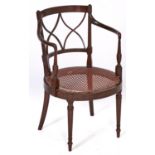 A mahogany and line inlaid elbow chair, early 20th c, in Regency style, with caned circular seat,