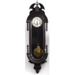 A mahogany-stained Continental wall clock, c1880, arched moulded case with ornate cornice with