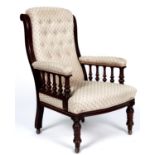 A Victorian mahogany armchair, the buttoned back between scrolling uprights, the padded arms on