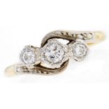 A three stone diamond crossover ring, gold hoop marked 18ct PLAT, 3.3g, size K½