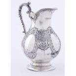A Victorian silver cream jug, chased with strapwork, 12cm h, Sheffield 1872, 5ozs