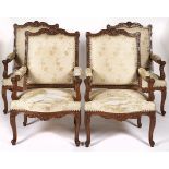 A set of four French walnut armchairs, first half 20th c, in Louis XV style, with padded back and