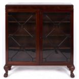 A mahogany bookcase, c1930, fitted with adjustable shelves enclosed by a pair of glazed thirteen