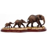 A Border Fine Arts painted resin group of elephants - Follow My Leader, wood base, 56cm l
