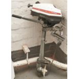 A Honda four stroke outboard engine and spare propeller