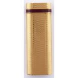 A Le Must de Cartier gold plated and red enamel cigarette lighter, maker's box, guarantee dated 1992