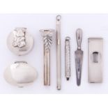 A silver cigar cutter, two pill boxes, lapel flower holder, swizzle stick and two other articles,