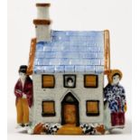 A Yorkshire pearl ware cottage moneybox, Mexborough, c1830, decorated in the Pratt palette, 12.5cm h