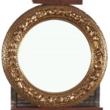 A circular giltwood and composition mirror, 20th c, 62cm diam